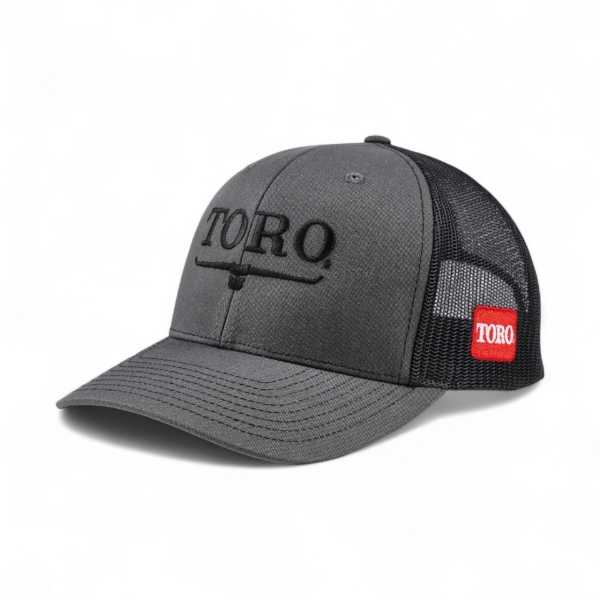 Toro Richardson 112 Charcoal Hat 2.0 Front Angled Photo showing Toro Vintage logo on front of cap in black and Red Toro Shield logo on wearer's left mesh panel of hat.